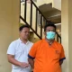 Ayah Farel Prayoga berbaju tahanan oranye bermasker digiring petugas di area tangga kantor polisi Banyuwangi.